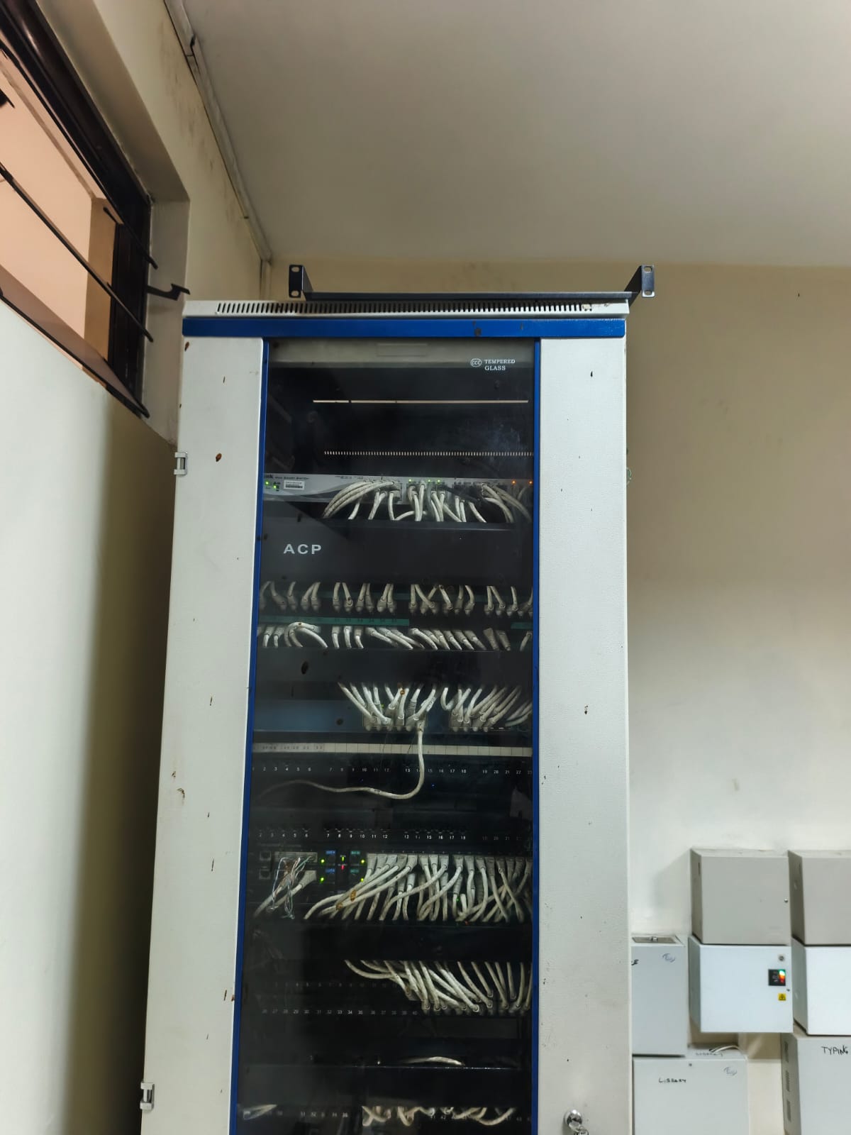 Technician carrying out an on-site installation at a building exterior